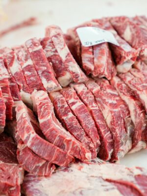 A close-up shot of sliced beef in a meat processing setting, showcasing freshness and detail.